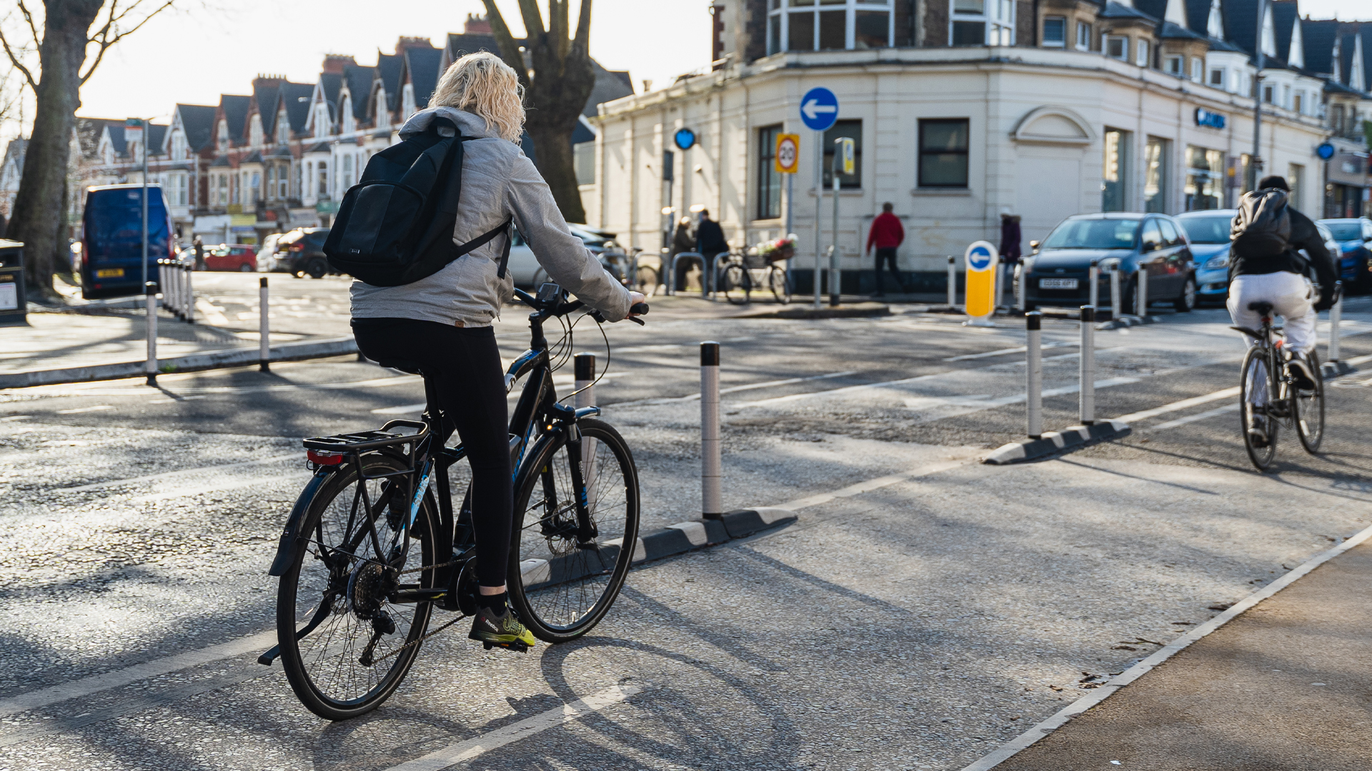 Two people riding in the bicycle lane in Wales